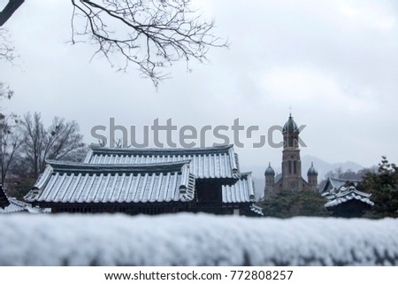 Snow covered Korean traditional stone wall and roof tile