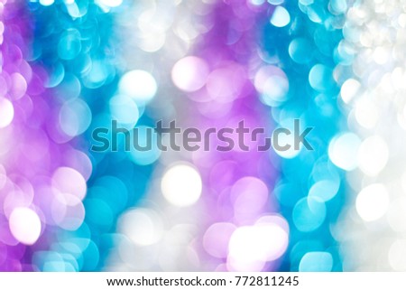 New years backgrounds defocused effect light glowing bokeh blue pink trendy colour. Shiny Christmas decoration beautiful wrapping photo