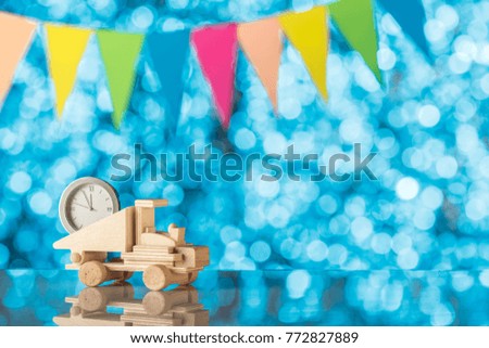 Background for Your design, festive flags. Wooden truck is bringing us a new year. Place for text. Blurred background.