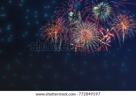 Beautiful colorful fireworks display for celebration on dark background with blur stars,  New year holiday concept