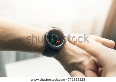 man using smart watch to receive a call