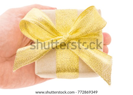 male hands holding gift with gold ribbon, top view