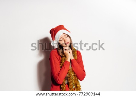Sad young woman in Santa Claus costume