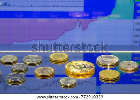 Golden Bitcoin - virtual crypto currency, financial concept, and coins of different countries, stock chart graph on blue background.