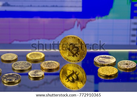 Golden Bitcoin - virtual crypto currency, financial concept, and coins of different countries, stock chart graph on blue background.