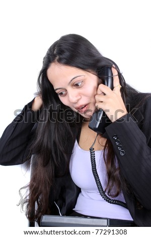 A beautiful Indian businesswoman talking on the phone.
