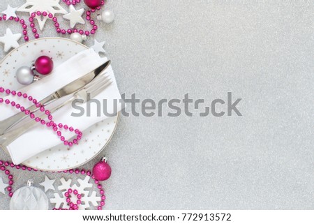 White, silver and pink Christmas Table Setting  with christmas decorations 