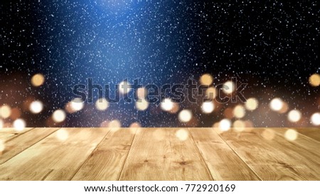 Table background of free space for your decoration. New year time decoration. Blurred lights. 
