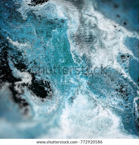 Abstract liquid blue background. Pattern with abstract frozen and black waves. Marble. Handmade surface. Liquid paint. Acrillic wallpaper. Mineral frost texture.