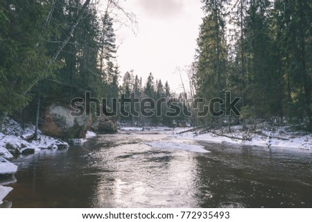 scenic wetlands with country lake or river in winter. reflections in water with forest and grassland - vintage retro look