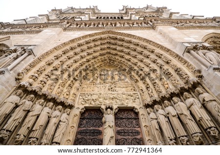 Main Entrance door. Cathédrale Notre Dame de Paris. Ornate Facade with sculptures statues and gargoyles. France