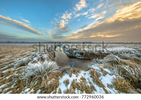 Frozen river in northern part of the province of Drenthe in the Netherlands on a cold morning