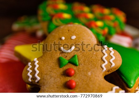 Plate with different christmas gingerbread cookies on rustic wooden table