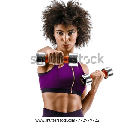 Sporty girl doing boxing exercises, making direct hit with dumbbells. Photo of african girl on white background. Strength and motivation