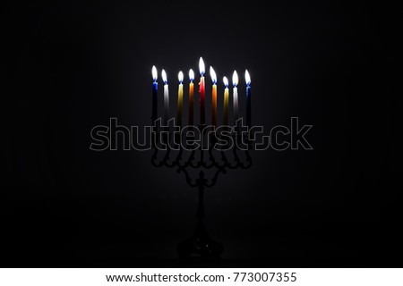 Hanukkah Menorah with candles lightning on a dark black background Jewish holidays symbol lit