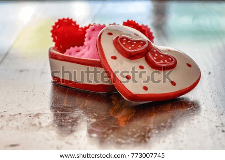 Valentine decorations on wood table in natural light with room for text