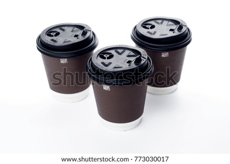Dark brown paper cup on white isolated background, selective focus, shallow depth