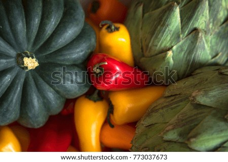 Overhead picture of Artichokes, Red Peppers, Yellow Peppers and Green Squash.