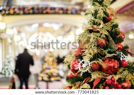 Photo of decorated Christmas tree with red and gold ornaments