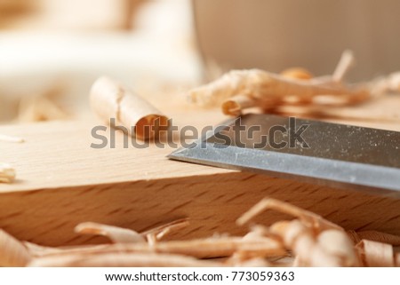 DIY concept. Woodworking and crafts. Chisel. plane and stock on the workbench. Top view. Wooden background. 