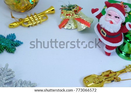 Merry Chrismas background which in side picture show Santa Claus doll ,gold bell , trumpet , guitar and the star with white background color.
