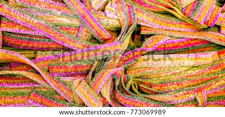 Different fruit candies. Colorful bright chewy candies covered with sugar. Rainbow ribbon candies.