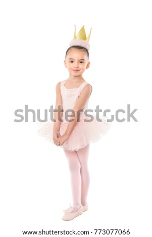 Four year old little girl in ballerina outfit on white background, wearing a paper gold crown