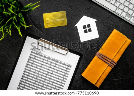 Mortgage payment schedule near bank card and wallet on black background top view