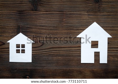 Get a mortgage. House silhouette on dark wooden background top view copyspace