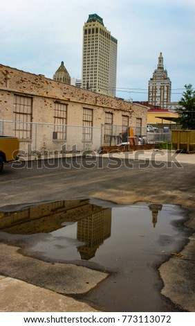 Skyline of Tulsa Oklahoma USA reflected in a puddle in a parking lot