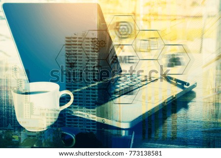 Double Exposure of image of laptop ,coffee ,smartphone  with business building. Digital Business and Technology Concept.