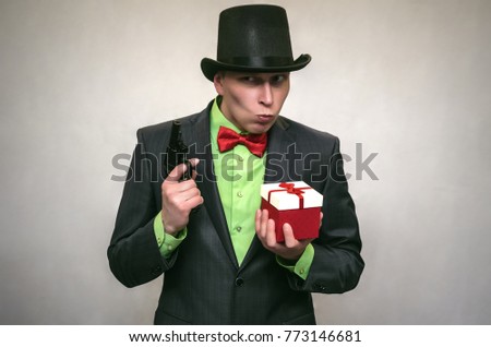 Christmas present box in the hands of confused secret detective agent isolated on white. Secret service. The spy concept.
