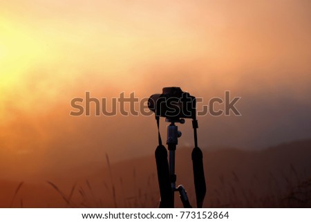 Digital camera standing in sunset