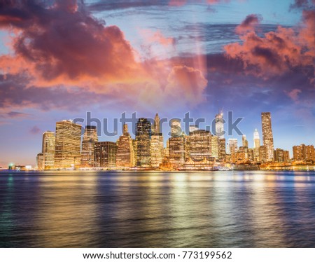 Downtown Manhattan sunset light with river reflections from Brooklyn, New York City.