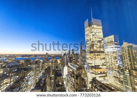 Night skyline of Manhattan. City lights at sunset.