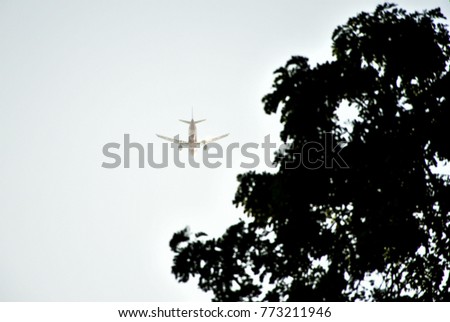 Commercial Airplane Flying Above Clouds In Dramatic Sky. Selective Focus. Image For Templates, Placards, Banners, Presentations, Reports, Card And Wallpaper. etc