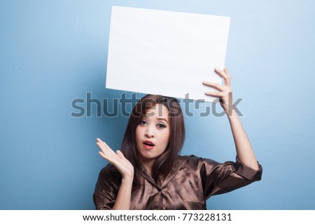 Young Asian woman surprise with white blank sign on blue background