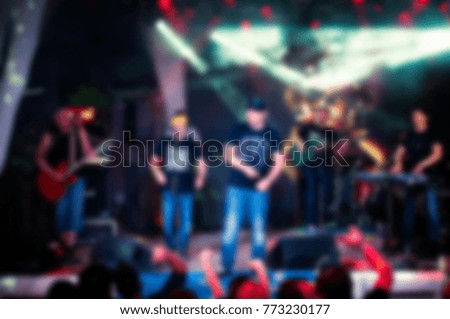 Blurry night club dj party people enjoy of music dancing sound with colorful light. club night light dj party With Smoke Machine and lights. Dark colored background