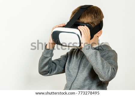 Boy with a headset of virtual reality. Innovative technology. On an white background.
