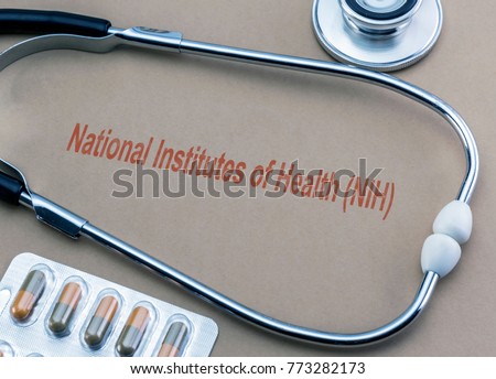 Stethoscope and capsules, digital composition with the text National Institutes of Health (NIH), conceptual image