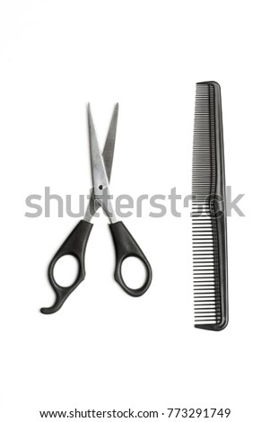 Scissors and a plastic comb on a white background