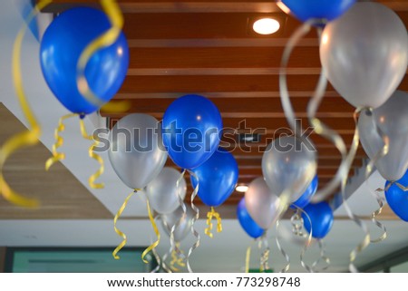 Blue and white balloons in office