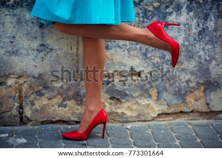 Walking female legs, red shoes, blue dress, woman lower half, close up, stone square, fashion background