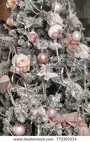 Christmas background, yellow, white and dark, with snowy pine branches, icy roses and lights.