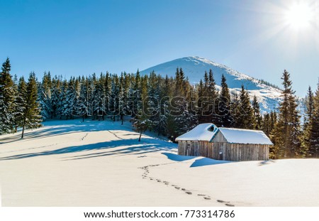 Beautiful winter landscape in the mountains with snow path in steppe and small little houses. Happy New Year celebration concept.