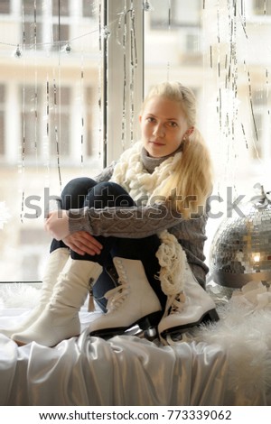 Winter photo of the girl with ice skates.