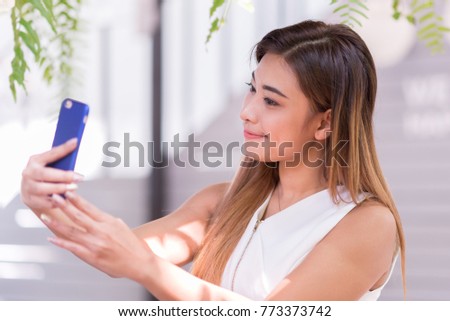 Beautiful women are happily selfie in garden. Selected focus