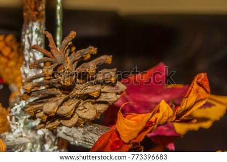Dry pine cone and multi color leaves christmas tree natural decoration closeup.
