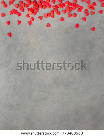 Valentines day background with  red hearts. Sweet candy hearts on a gray concrete background. Romantic mood.) Beautiful background.
Flat lay, top view