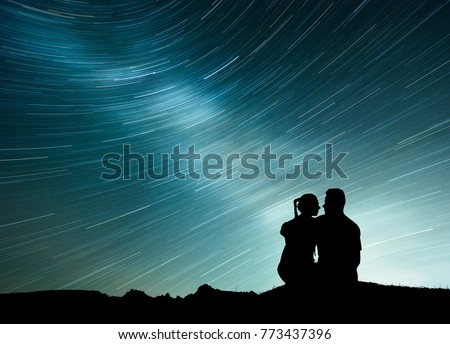 Milky Way with silhouette of people. Landscape with night starry sky. Standing man and woman on the mountain with star light. Beautiful galaxy. Universe.